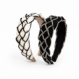 Two black and white woven headbands on a white background