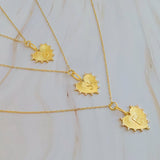 A collection of gold-plated heart-shaped initial necklaces displayed on a surface.