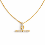 A gold chain necklace featuring a sparkling pavé T-bar pendant. The design combines a classic toggle motif with shimmering details for a sophisticated and modern finish.