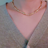 Gold-toned necklace featuring sleek tube beads – minimalist and modern layered style