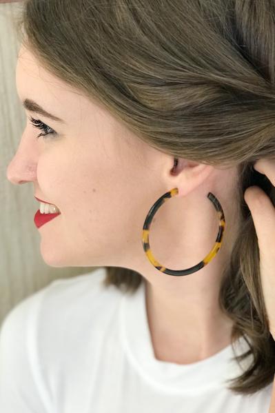 Model wearing large tortoise hoop earrings from online Jewelry Boutique Ellison + Young