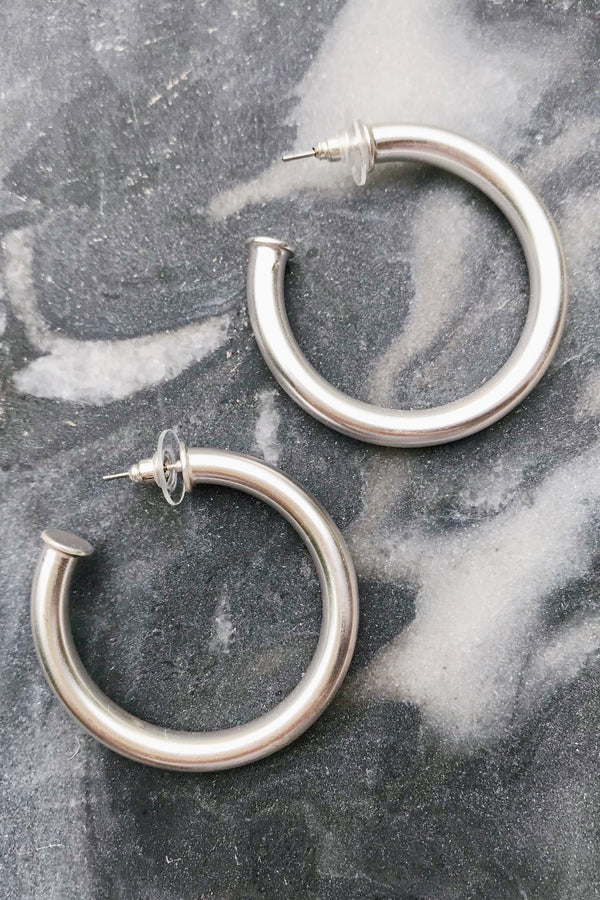 Small tube matte silver hoop earrings from online Jewelry Boutique Ellison + Young