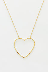 gold chain necklace with hammered heart pendant displayed on white background