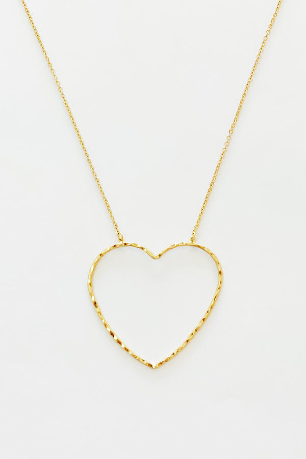 gold chain necklace with hammered heart pendant displayed on white background