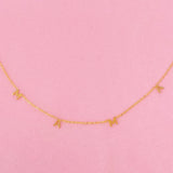 Gold chain necklace featuring a “Mama” initials in a polished gold finish, designed as a meaningful everyday or giftable piece.