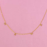 Gold chain necklace featuring spaced letter charms that spell “NANA” in a polished gold finish, designed as a meaningful everyday or giftable piece.