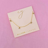 Gold chain necklace featuring spaced letter charms that spell “NANA” in a polished gold finish, designed as a meaningful everyday or giftable piece.