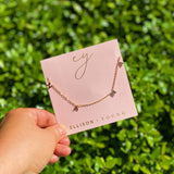 Gold chain necklace featuring spaced letter charms that spell “NANA” in a polished gold finish, designed as a meaningful everyday or giftable piece.